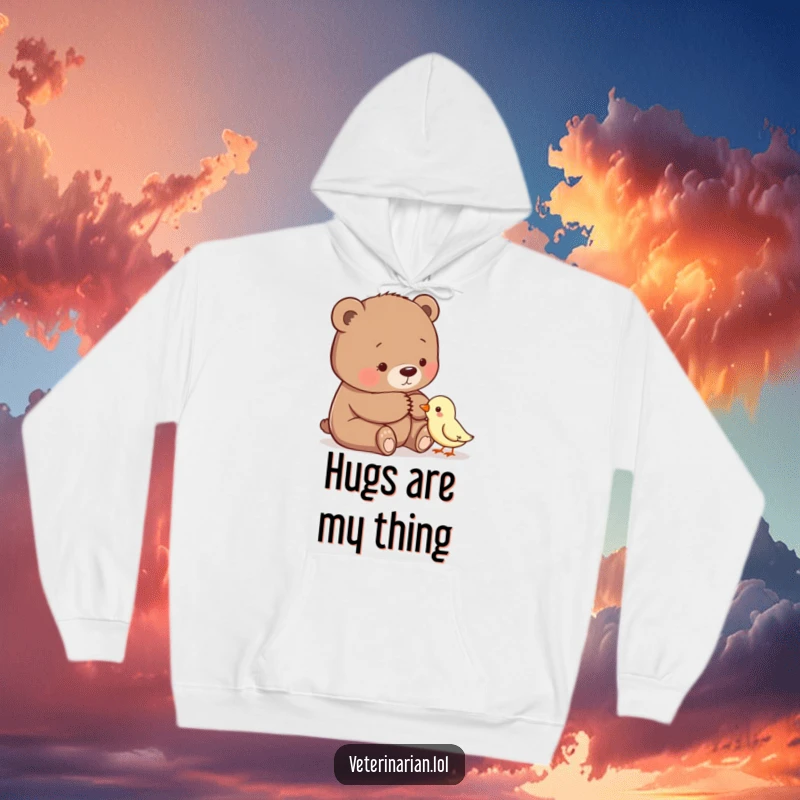 Funny hoodie depicting a gentle bear offering a comforting pat to a small bird, embodying warmth and empathy.
