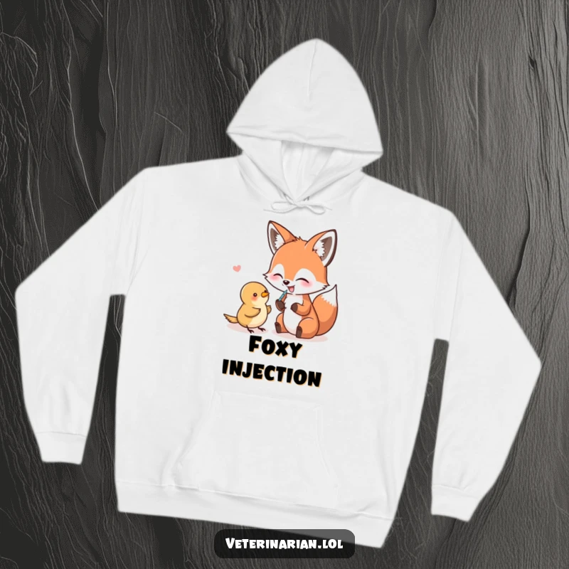 Funny Hoodie depicting a giggling fox attempting to give a small bird an injection with a needle, full of humorous intent.