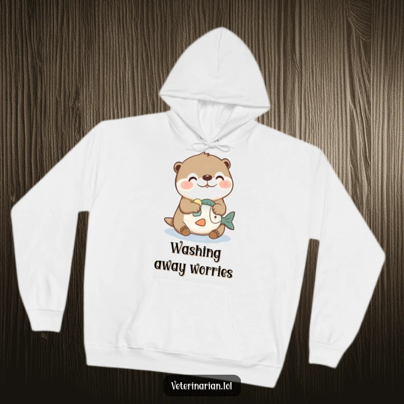 Funny hoodie with a joyful otter character cleaning a toy fish with a sponge, radiating comfort and playful energy.